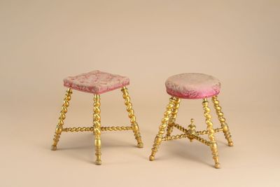 pair of antique brass stools with pink velvet upholstered seat