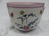 a white bowl with a pink rim and flowers on it