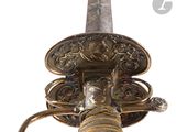 un gros plan d'une épée dotée d'une poignée en métal