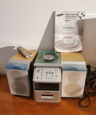 several speakers and a remote sitting on a table