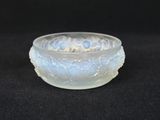 a close up of a glass bowl on a black surface