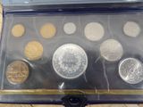 an assortment of coins in a case sitting on a table