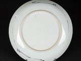 a close up of a plate on a black surface with a black background