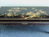 a black table with a bird design on it
