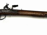 an old rifle with a wooden barrel on a white background