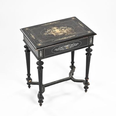 black and gold decorated side table on a white background