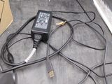 a box with wires and a remote on the floor