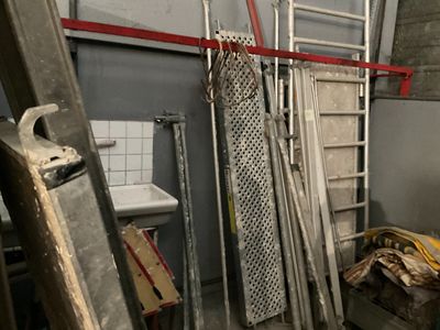 une pièce avec une échelle, un lavabo, des toilettes et une échelle