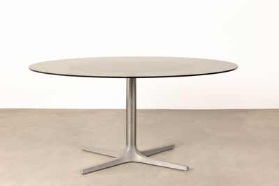 a round table with a metal base and a glass top