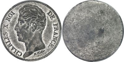 a close up of a coin on a white surface