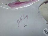 a close up of a white vase with a pink flower on it