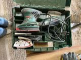 a green box with tools in it sitting on the ground