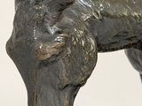 a bronze statue of a bull on a white background
