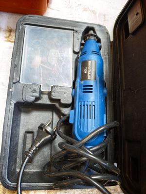 a blue electric drill sitting in a black case