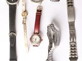 a lot of watches that are laying out on the table