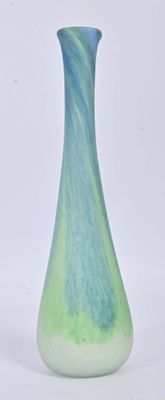 a blue and green vase sitting on a white surface