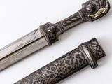 two different types of knives on a white surface