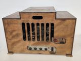 an old radio with a wooden case sitting on top of a table