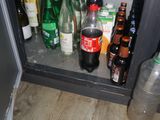 many bottles of alcohol and bottles of water on the shelf