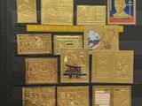 a picture of a display of gold stamps on a black board