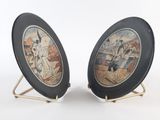 pair of black and gold plate with a picture of a woman and a man