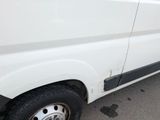a white van that is parked on the side of the road