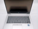 an open laptop computer sitting on top of a white table