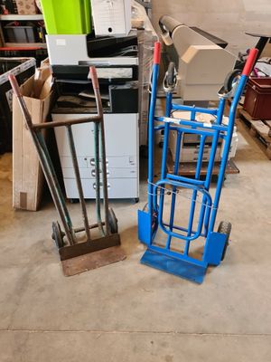 a blue hand truck with a box on top of it
