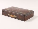 brown wooden box with floral decoration on top of it