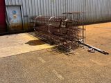a metal cage that has a bunch of animal in it