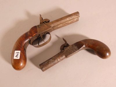 an old gun with a wooden handle on a white surface