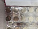 a lot of different coins in a plastic case
