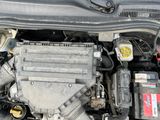 the engine of a car with its hood open and a battery in it