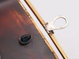 a close up of a purse with a key in it