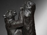 bronze sculpture of two bears hugging each other on a marble base