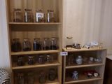 a wooden shelf with glass jars on it in a room