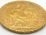 a close up of a gold coin with a rooster on it