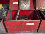 two red boxes with tools in them sitting on the floor