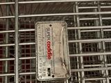a metal cage that has a tag on it