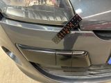 a sticker on the front bumper of a car that has a sticker attached to it