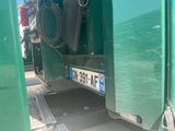 a green truck that has a license plate on it