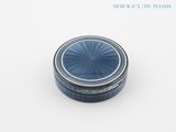 a small blue box with a lid sitting on a table