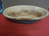 a dirty bowl sitting on a table with a red table cloth
