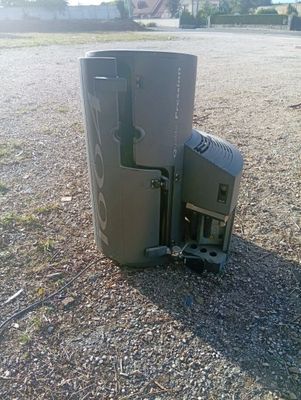 a trash can that is sitting in the middle of the road