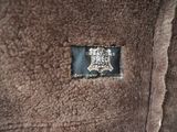 a badge on the back of a brown jacket