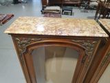 a marble top cabinet in the middle of a room