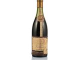 a bottle of wine sitting on top of a white surface