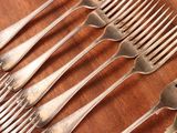 a lot of forks that are sitting on a table