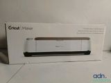 packaging of a cricut maker in a box on a table