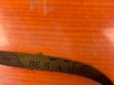 close up of a violin with a label on the back of it
